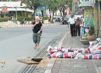 The offending hole without its drainage cover poses a hazard to pedestrians and motorists alike.
